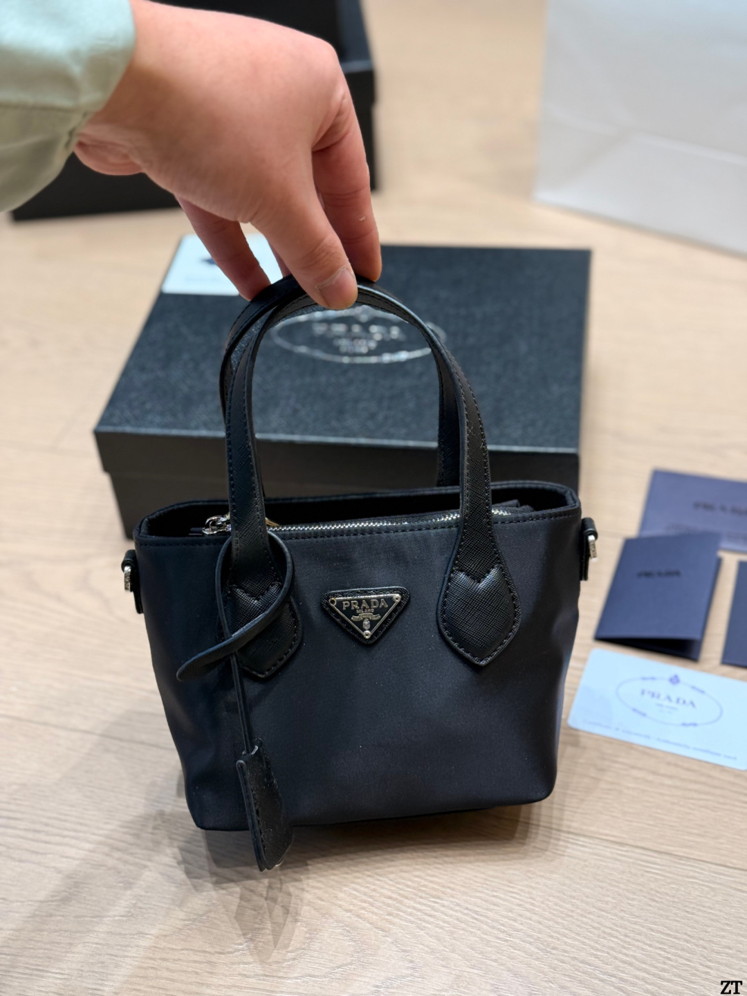 . Prada Nylon Handbag Prada’s classic nylon Handbag is made of iconic parachute - Image 10